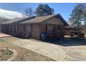 The home features a brick exterior and a concrete driveway leading to a backyard deck at 1655 Old Salem Rd, Covington, GA 30013