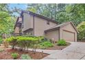 Beautiful home exterior with an attached garage and a well-manicured lawn at 3625 N Berkeley Lake Nw Rd, Berkeley Lake, GA 30096