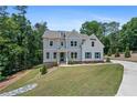 Beautiful two-story home with a manicured lawn, set against a backdrop of mature trees at 3790 Chattahoochee (Lot 33) Rd, Cumming, GA 30041