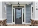 Close-up of the front door, showing the sidelights, transom window, and brick accents at 3790 Chattahoochee (Lot 33) Rd, Cumming, GA 30041