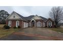 Beautiful single-story brick home with an arched entryway and side-entry garage at 1205 Peeksville Rd, Locust Grove, GA 30248