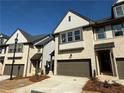 Charming exterior view of modern townhomes featuring brick, siding, two-car garages, and inviting entrances at 3904 Allegretto Cir # 50, Atlanta, GA 30339