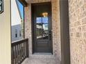 Inviting front door with glass panels, set in a charming brick facade with a covered porch at 3904 Allegretto Cir # 50, Atlanta, GA 30339