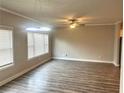 Open-concept living area with hardwood floors and modern light fixtures at 4421 Fulson Dr, Lilburn, GA 30047