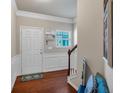 Bright entryway featuring hardwood floors, wainscoting, and a staircase at 553 Oakside Pl, Acworth, GA 30102