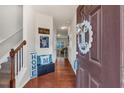 Welcoming entryway with hardwood floors, staircase, and stylish decor at 553 Oakside Pl, Acworth, GA 30102