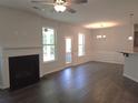 Bright open living room with fireplace, wood flooring, and large windows at 680 Sundial Ln, Mableton, GA 30126