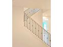 Bright staircase featuring modern black iron railings and an elegant light wood banister at 680 Sundial Ln, Mableton, GA 30126