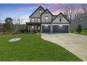 Charming two-story home with a well-maintained lawn, perfect for suburban living at 372 Garnet Dr, Acworth, GA 30101
