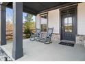 Inviting front porch with rocking chairs, a welcoming door and a view of the yard at 372 Garnet Dr, Acworth, GA 30101