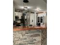 Kitchen featuring stone breakfast bar with modern lighting and view to stainless steel appliances at 101 Flagler Way, Dallas, GA 30157