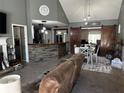 Cozy living room with stone accent wall, plush seating, and barn doors opening to the office at 101 Flagler Way, Dallas, GA 30157