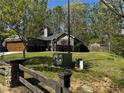 Lush green yard surrounds a charming single-story home with mature trees providing ample shade at 101 Flagler Way, Dallas, GA 30157