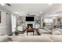 Comfortable living room featuring a fireplace, neutral decor, and an open layout connected to the dining area at 1445 Wheatfield Dr, Lawrenceville, GA 30043