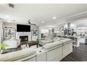 Spacious living room featuring a fireplace, large sectional sofa, and an open view of the kitchen at 1445 Wheatfield Dr, Lawrenceville, GA 30043