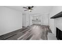 Bright living room featuring modern flooring and a cozy fireplace, with kitchen view at 2571 Hamill Dr, Buford, GA 30519