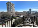 Balcony view of a cityscape with mature trees and mid-rise buildings at 2626 Peachtree Nw Rd # 1007, Atlanta, GA 30305