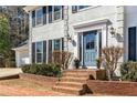 Inviting front entrance showcases a blue door, brick steps, and manicured landscaping at 2999 Timberlea Lake Se Way, Marietta, GA 30067