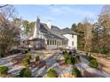 Manicured backyard showcasing professional landscaping and mature trees at 5323 Presley Pl, Douglasville, GA 30135