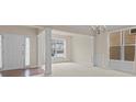 Bright living room with carpet, large windows, and a chandelier at 5480 Beaver Ridge Dr, Cumming, GA 30040