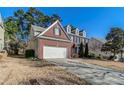 View of a charming brick and siding home with a two-car garage and well-maintained landscaping at 1011 Buckhorn Bnd, Locust Grove, GA 30248
