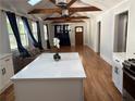 Open-concept living area featuring hardwood floors, vaulted ceiling, and kitchen island at 1575 Montreat Pl, Atlanta, GA 30311