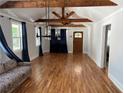 Bright open-concept living area featuring hardwood floors, vaulted ceiling, and natural light at 1575 Montreat Pl, Atlanta, GA 30311
