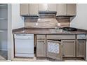 Functional kitchen with tiled backsplash, essential appliances, and wooden cabinetry at 3524 Exeter Ct, Snellville, GA 30039