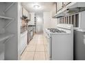 Functional kitchen featuring essential appliances, tiled flooring, and ample shelving at 3524 Exeter Ct, Snellville, GA 30039