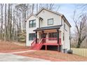Inviting two-story home with bright red porch, black accents, and a cozy, well-lit exterior at 4041 Blanton Sw Ave, Atlanta, GA 30331