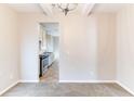 Bright dining room featuring neutral walls, carpeted floor, and view into kitchen at 7434 Rudder Cir, Fairburn, GA 30213