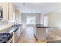 Open kitchen with granite countertops, stainless steel appliances, and an island at 7434 Rudder Cir, Fairburn, GA 30213