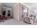 Inviting covered front porch with rocking chairs, brick columns, and a decorative front door at 131 Riverside Ln, Woodstock, GA 30188