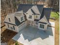 Newly constructed home featuring a two-car garage, light beige siding and a concrete driveway at 255 Olde Oak Dr, Jonesboro, GA 30238