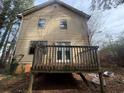 Backyard view of two-story home with siding and a porch at 5396 Kirk Dr, Atlanta, GA 30349