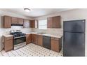 Eat-in kitchen featuring vintage cabinets and black appliances at 554 Sherwood Oaks Rd, Stone Mountain, GA 30087