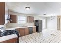 Eat-in kitchen featuring vintage cabinets and black appliances at 554 Sherwood Oaks Rd, Stone Mountain, GA 30087