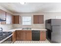 Eat-in kitchen featuring vintage cabinets and black appliances at 554 Sherwood Oaks Rd, Stone Mountain, GA 30087