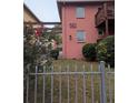 Pink two-story building with balcony and gated entry showcases unique architectural design at 561 Formwalt Sw St # 12, Atlanta, GA 30312