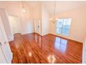 Bright living room featuring hardwood floors, high ceilings, and elegant light fixtures at 6025 Ashbury Ln, Cumming, GA 30028