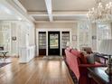 Elegant living room with hardwood floors, coffered ceiling, and large windows, offering ample natural light at 121 17Th Ne St, Atlanta, GA 30309