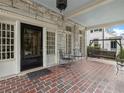 Inviting brick porch with swing, seating, and classic architectural details; ideal for relaxing outdoors at 121 17Th Ne St, Atlanta, GA 30309