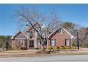 Beautiful two-story brick home with a landscaped yard and traditional architectural details at 1279 Saxony Se Dr, Conyers, GA 30013