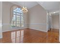 Elegant dining room with large window, hardwood floors, modern chandelier, and neutral paint at 17 Vickers Pl, Douglasville, GA 30134