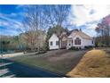 Lovely home with a well-manicured lawn and mature trees creating a serene setting next to the neighborhood playground at 17 Vickers Pl, Douglasville, GA 30134