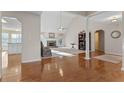 Open-concept living area with fireplace, hardwood floors, and seamless flow to the kitchen at 17 Vickers Pl, Douglasville, GA 30134
