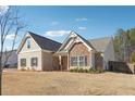 Well-maintained single-Gathering home featuring brick and stone accents, set against a bright blue sky backdrop at 2808 Blandwood Rd, Marietta, GA 30064