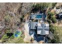 Stunning aerial view of estate with pool, tennis court and mature trees at 3980 Saint Elisabeth Sq, Duluth, GA 30096