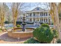 Stunning water feature in front of a two-story home with white pillars and black shutters at 3980 Saint Elisabeth Sq, Duluth, GA 30096