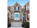 Attractive brick townhome with a bay window, one car garage, and inviting front entrance at 1286 Creekside Se Ter, Smyrna, GA 30082